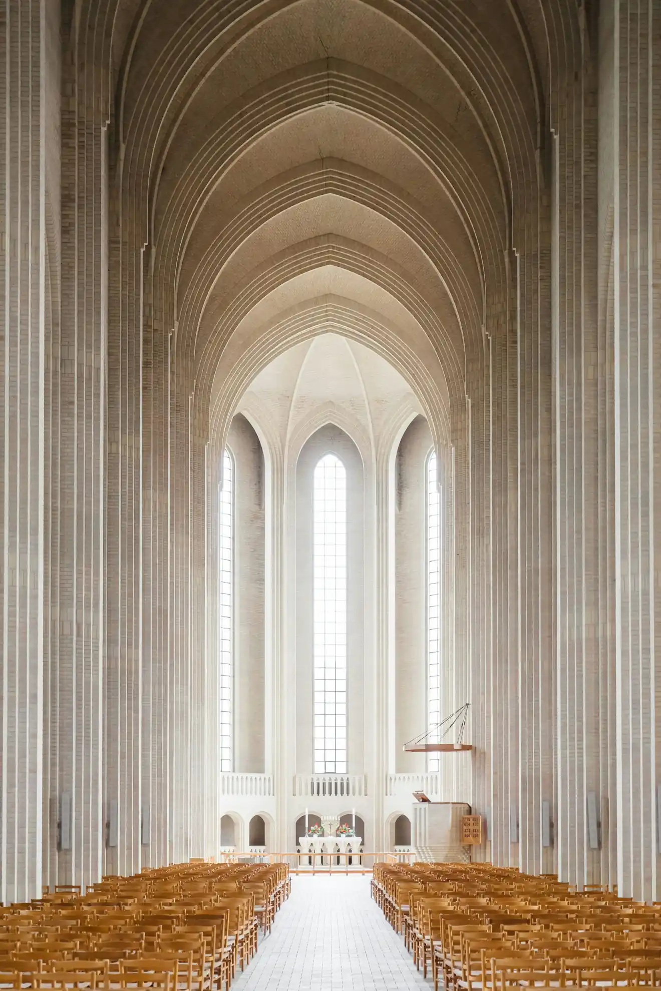 The nave of a cathedral, arches rising toward the light — a sacred space, under God