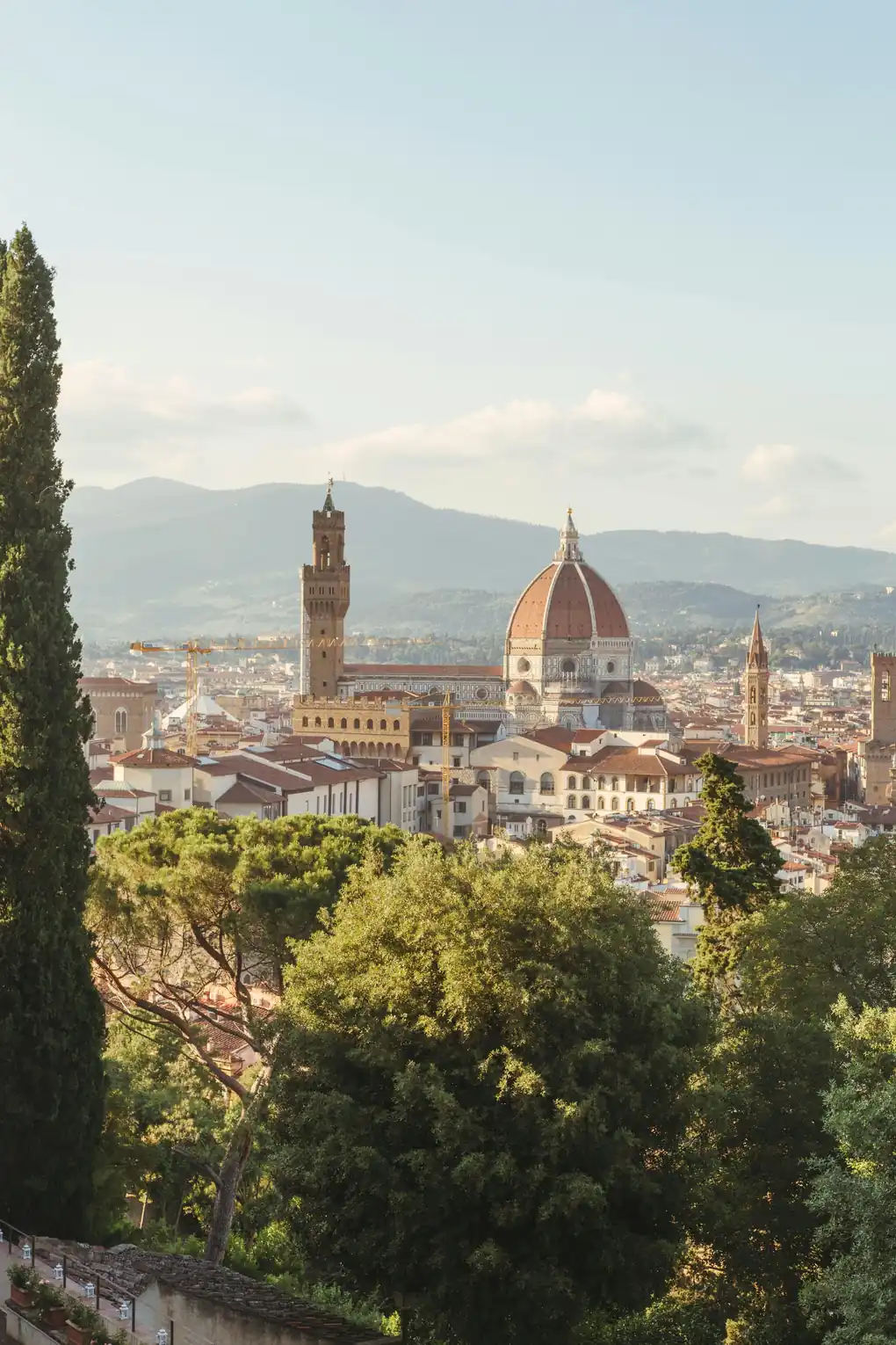 A view of Florence at golden hour — the Duomo rising above the rooftops